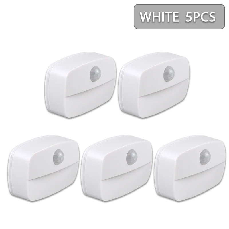 Five white motion sensor LED night lights are shown in a flat lay view.