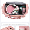 Pink large capacity travel duffel bag showing various compartments for clothing and accessories