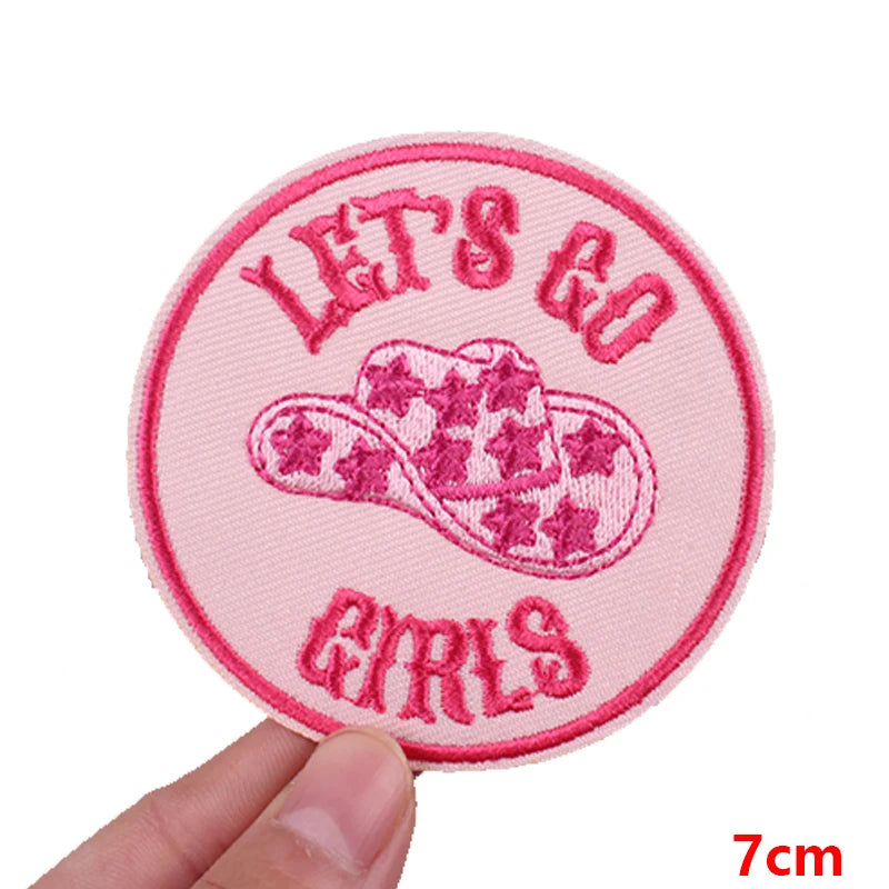 Pink embroidered patch with the text LET'S GO and GIRLS surrounding a pink cowboy hat design
