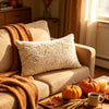 A cozy living room scene featuring an autumn pumpkin and maple leaf plush throw pillow cover on a sofa.