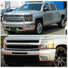 Close-up view of a silver truck's front bumper with an aftermarket fog light assembly installed.