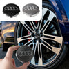 A black decorative hub cap for an Audi wheel, shown with and without the cover.