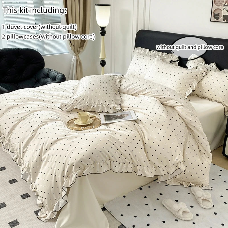 A set of three bedding pieces including a duvet cover, pillowcases, and pillow core with a black dot print design.