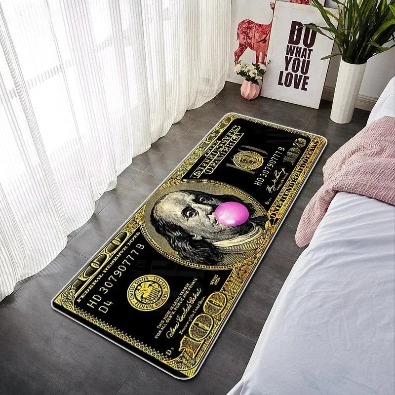 A rectangular black and gold banknote pattern anti-slip floor mat placed on a gray floor next to a white window.