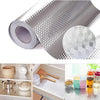 Roll of self-adhesive aluminum foil kitchen backsplash protector with a diamond pattern.