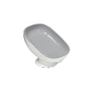 A white suction cup soap holder with a sloped design and drainage features.