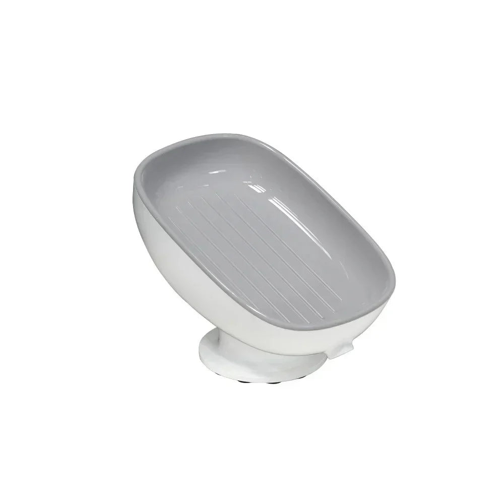 A white suction cup soap holder with a sloped design and drainage features.