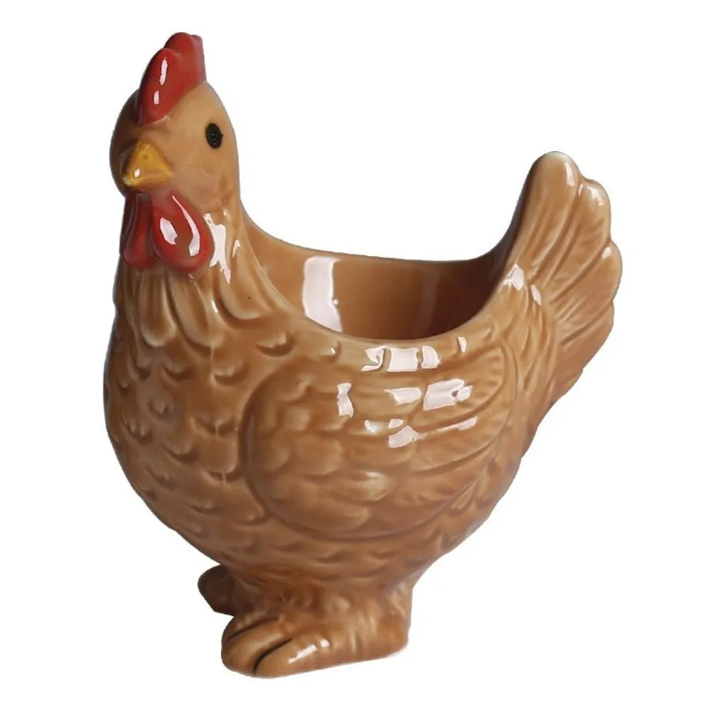 A ceramic chicken egg cup with a reddish comb and yellow beak.
