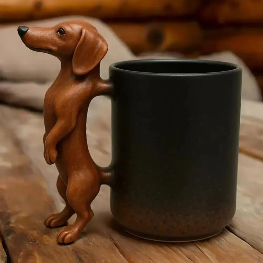 A brown dachshund coffee mug featuring a 3D puppy handle, resting on a wooden surface.
