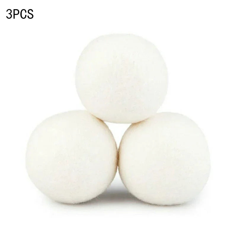 Three white natural wool dryer balls are shown against a white background.