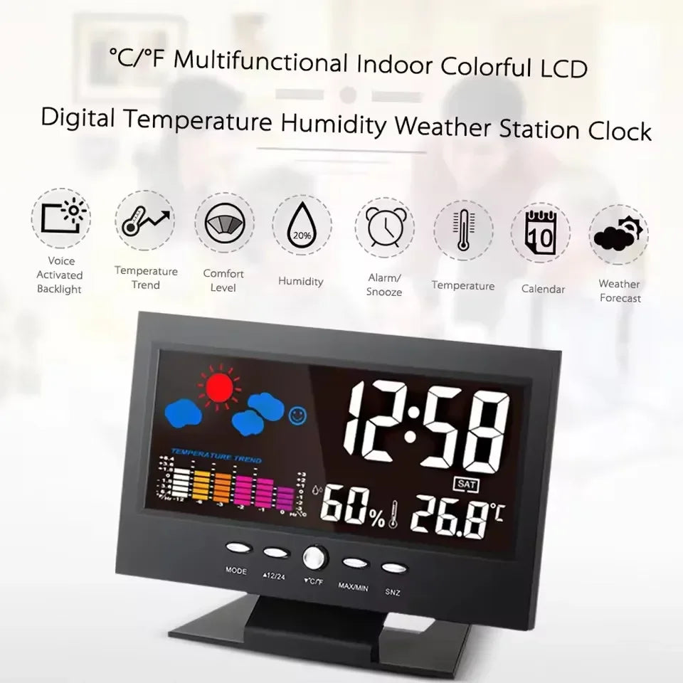 A digital indoor weather station clock displaying time, temperature, and humidity on a black screen.