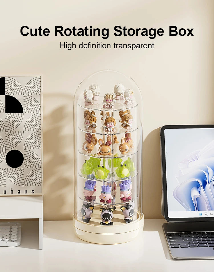 A clear rotating storage box filled with small collectible figures and keepsakes on a white surface.