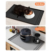 A black silicone mat protecting a pot on a kitchen counter.