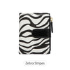 A black and white zebra stripes compact zippered wallet with a black flap.
