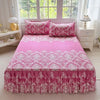 Pink floral print bed skirt and pillowcase set displayed on a bed with a light pink duvet.