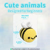 A yellow big bee crochet project with black stripes and white fluff, shown on a white background.