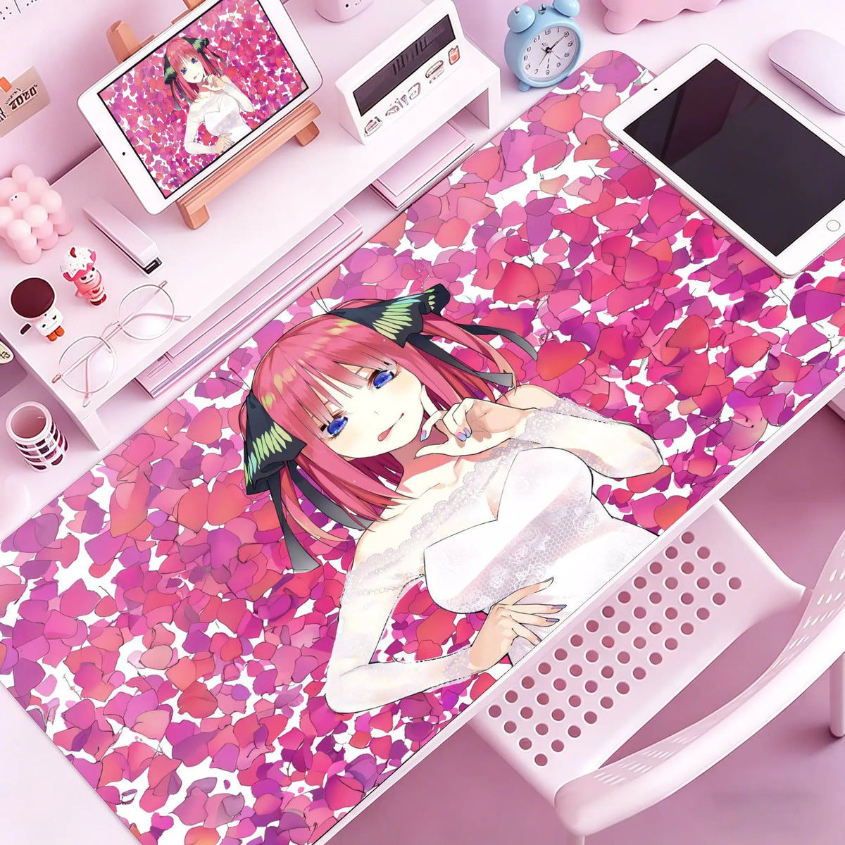 A pink anime character design mouse pad featuring a girl with pink hair and white clothing on a pink desk mat.