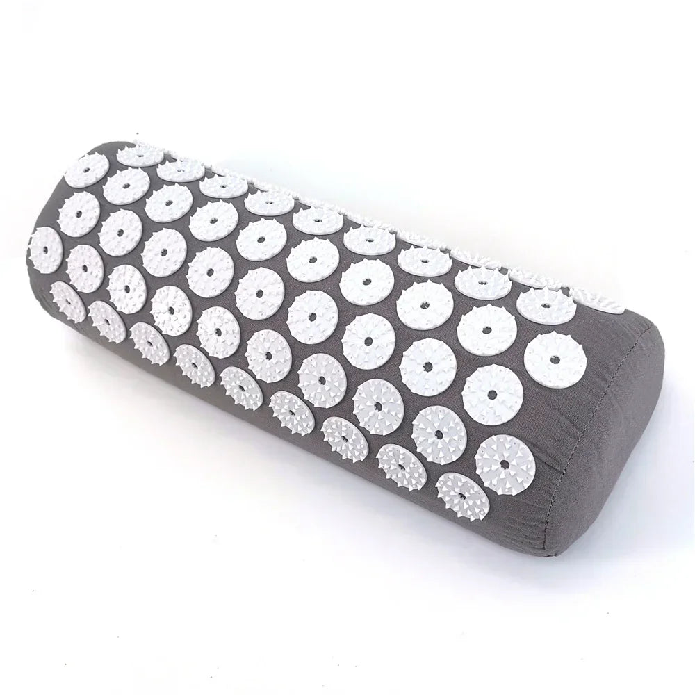 A dark gray acupressure mat and pillow set featuring white circular bumps for pain relief.