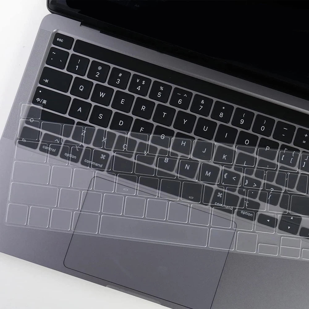 A close-up view of a transparent TPU keyboard cover for a MacBook, showing the keys and surrounding surface.