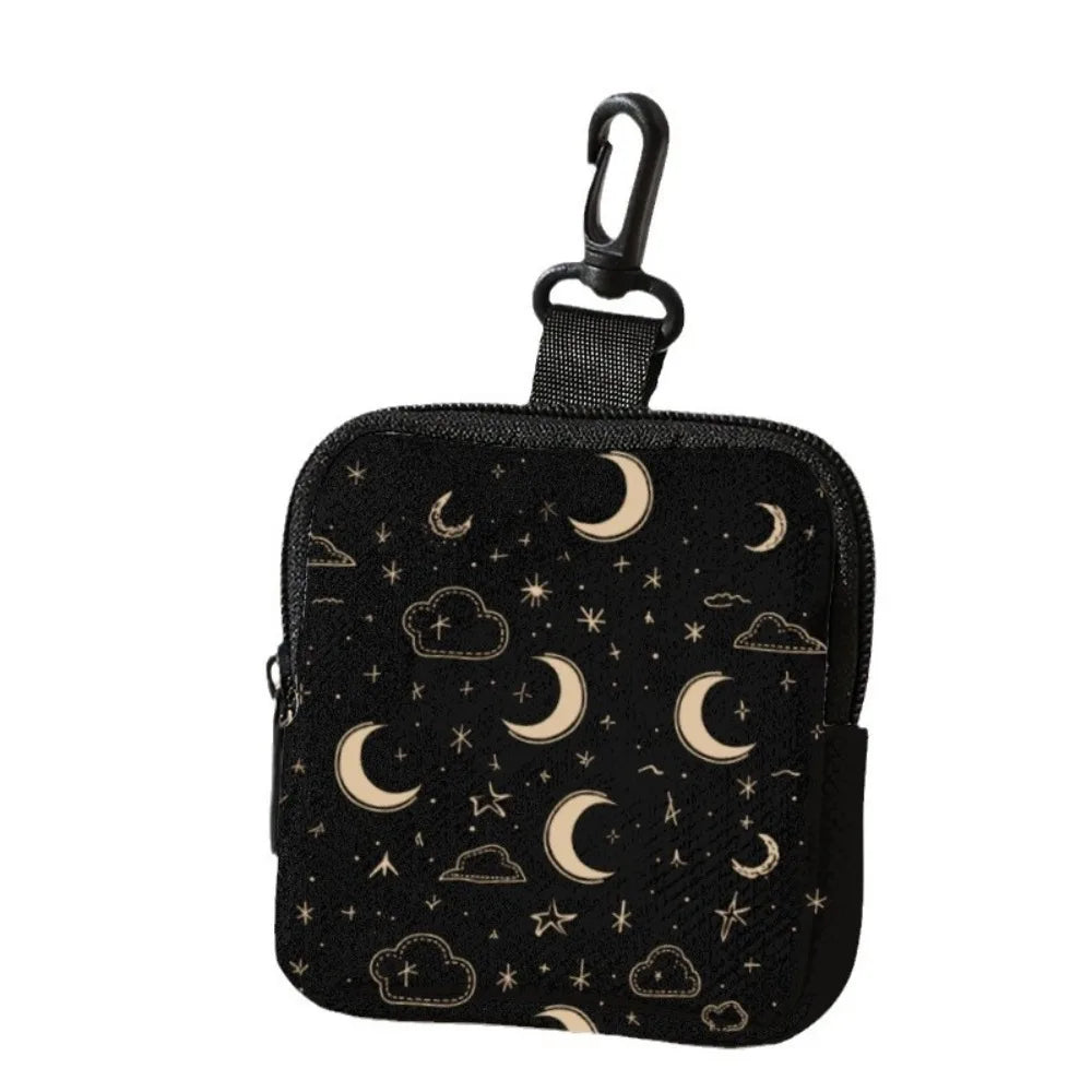 Black mini coin purse with a cat and dog print featuring crescent moons and stars.
