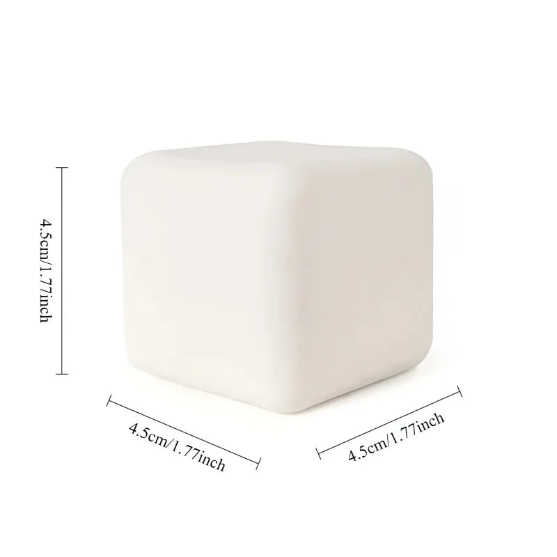 A white, square squishy milk tofu stress relief fidget toy shown from above.