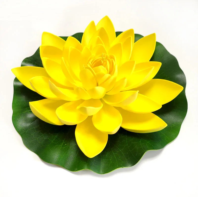 A vibrant yellow lotus flower rests on a green leaf, designed for pond and garden decor.