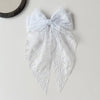 White lace bow hair clip accessory with delicate floral pattern