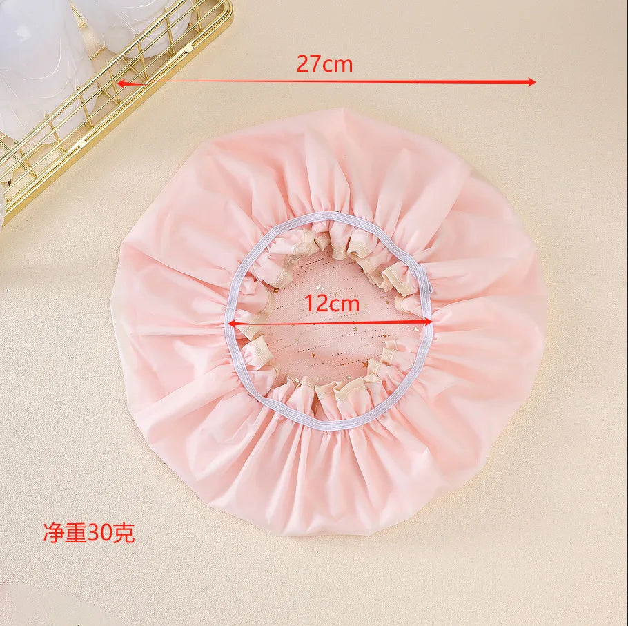 A pink reusable elastic shower cap with a 27cm diameter and a 12cm opening, shown on a light background.