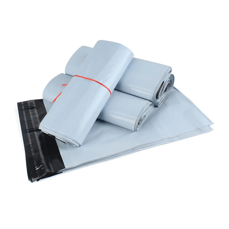 A stack of fifty clear plastic self-sealing mailing bags, some tied with orange string.