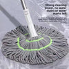 A gray hands-free self-wringing spin mop with a white handle and a rotating scrubbing head is shown on a surface.