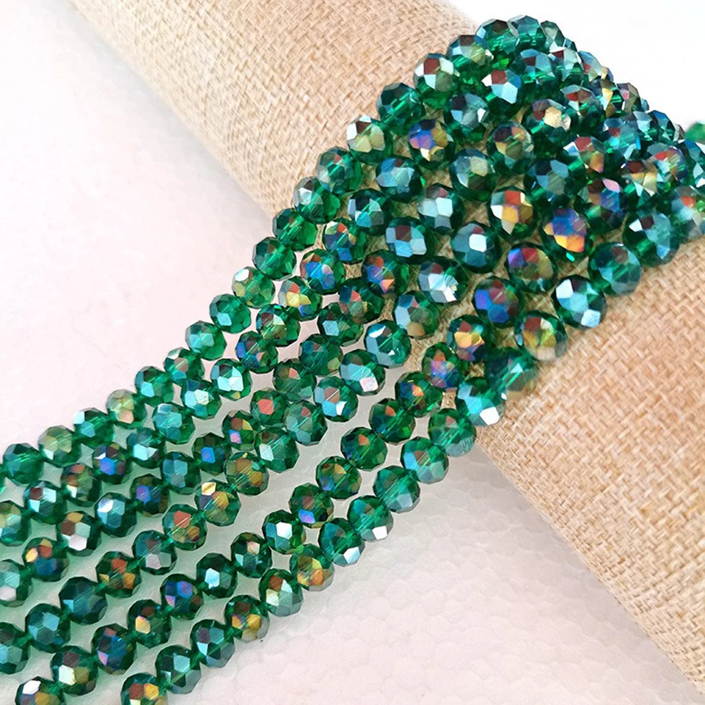 Green faceted crystal glass spacer beads strung on natural twine for jewelry making