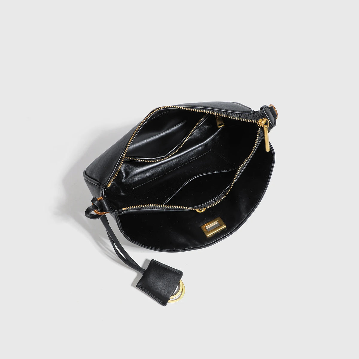 A black leather tote bag with gold-toned hardware and a flap closure.