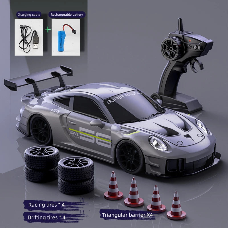 A silver RC drift truck model is shown with accessories like charging cables, racing tires, and a triangular barrier.