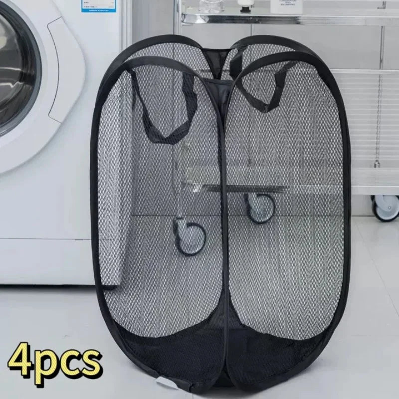 Four black foldable mesh laundry baskets with handles displayed on a white shelf.