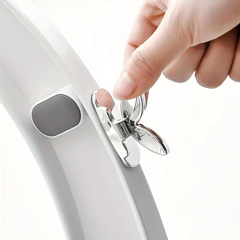 A hand is lifting a toilet seat using the flush button mechanism on a white toilet.