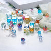 Assortment of colorful crystal ball beads and silicone molds for DIY jewelry making displayed on a white surface.