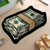 A black silicone rug featuring a design of stacked US hundred dollar bills on a light beige surface.