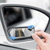 A hand adjusts a 360° adjustable pair of blind spot mirrors on a car door.