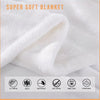 A white super soft blanket folded and draped, showing a fluffy texture.
