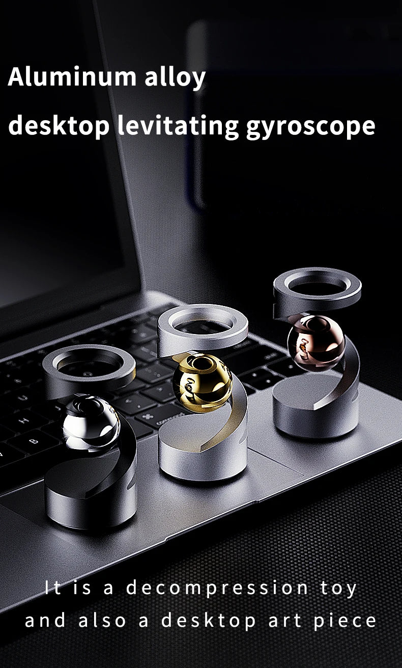 An aluminum alloy desktop levitating gyroscope resting on a laptop keyboard.