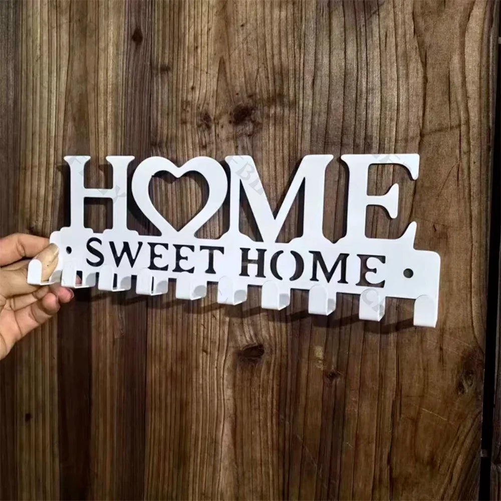 White wooden wall hooks shaped like the words HOME and SWEET HOME for home organization