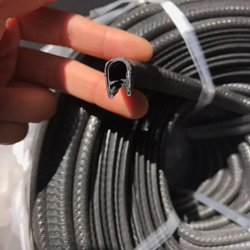 A hand holds a U-shaped rubber edge trim with a metal core, used for car doors and boats.