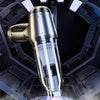 A close-up view of a silver cordless handheld vacuum cleaner with a clear nozzle emitting a powerful stream of air.