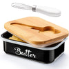 A metal butter dish with a wooden lid and a stainless steel knife resting on the dish.