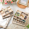 A light wood jewelry organizer tray filled with various gold and silver necklaces, rings, and earrings.