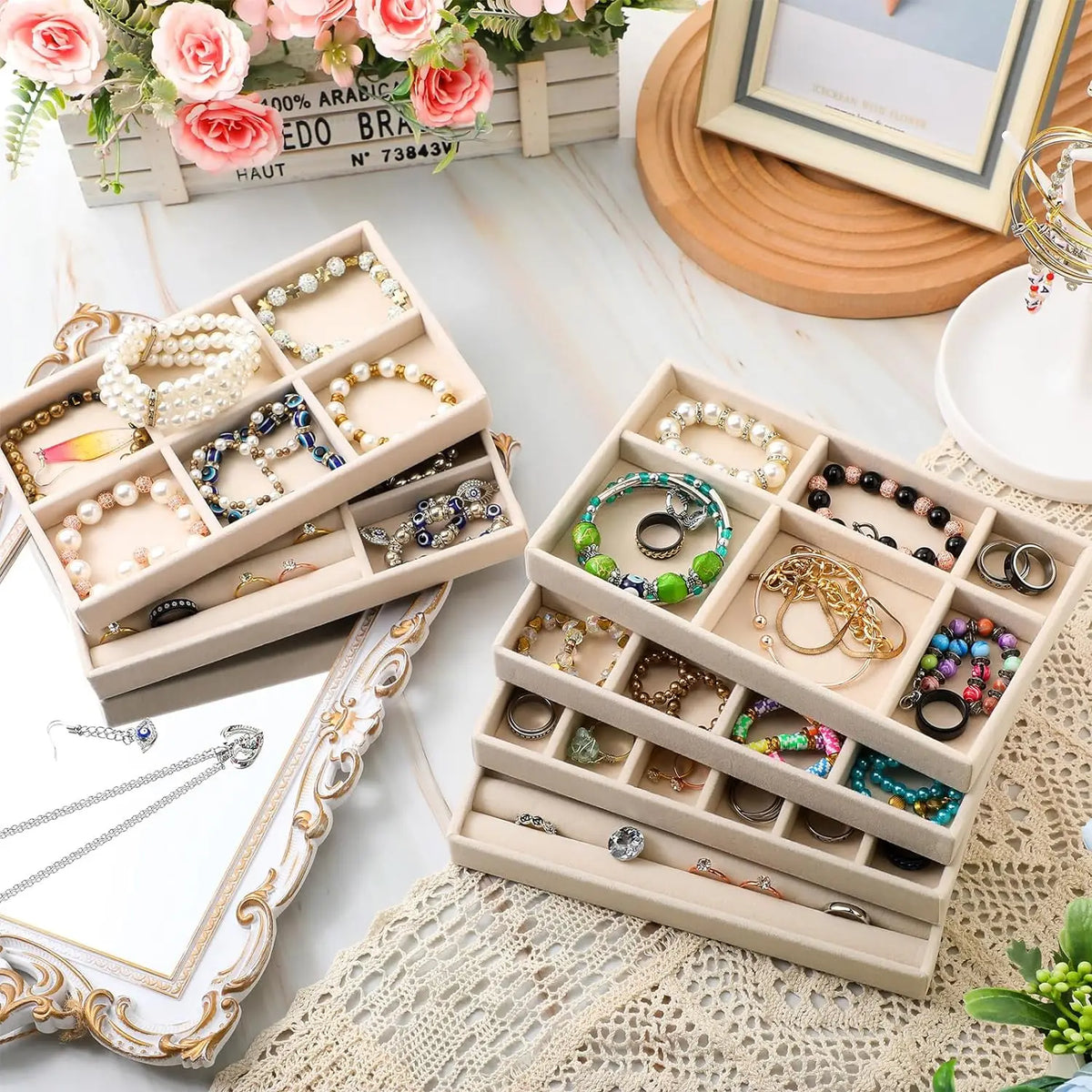A light wood jewelry organizer tray filled with various gold and silver necklaces, rings, and earrings.