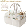 A beige corduroy baby diaper caddy organizer with handles showing various baby supplies like diapers and bottles.