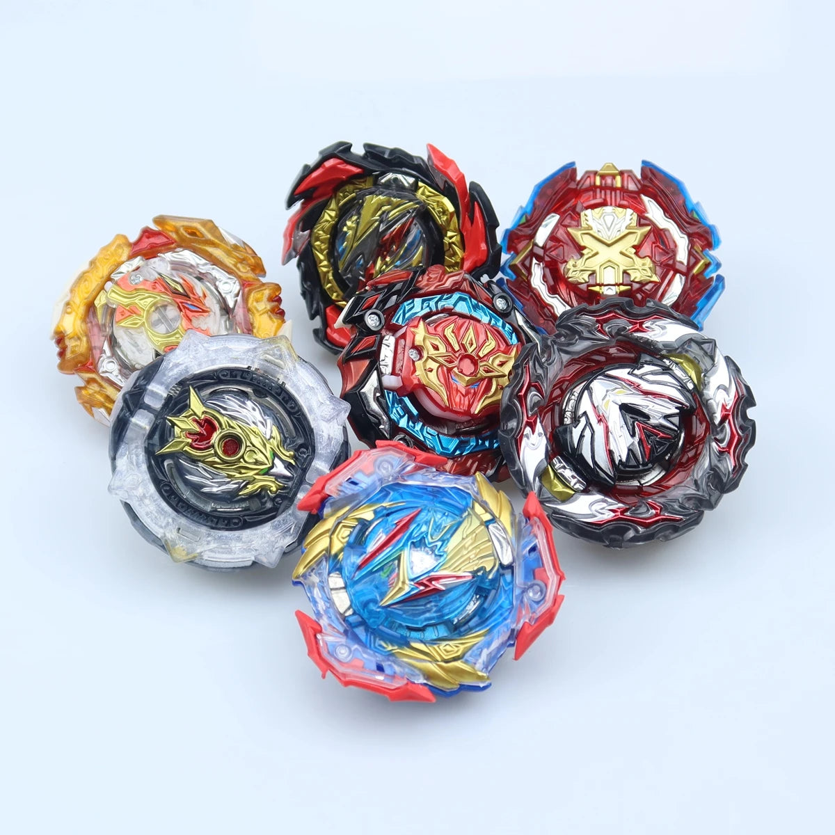 A collection of ten metal battle spinning tops in various colors including red, gold, black, and blue.