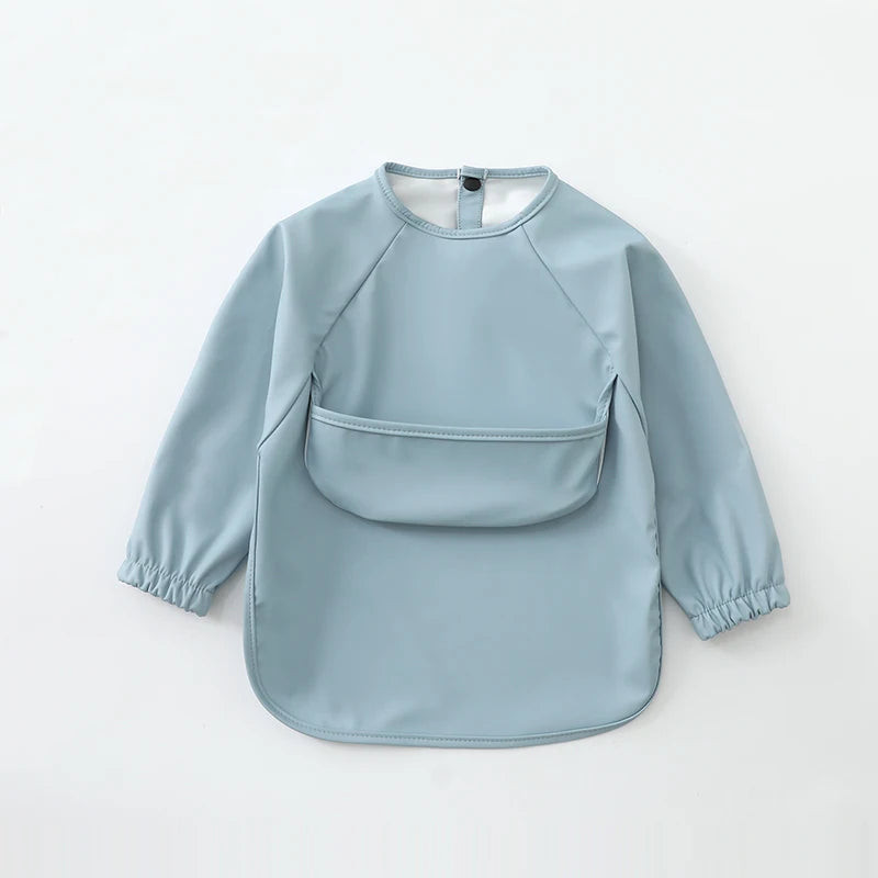 A light blue waterproof long-sleeve smock for toddlers with a rounded neckline and short sleeves.