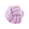A round, light purple knitted velvet throw pillow with a textured, knotted surface.